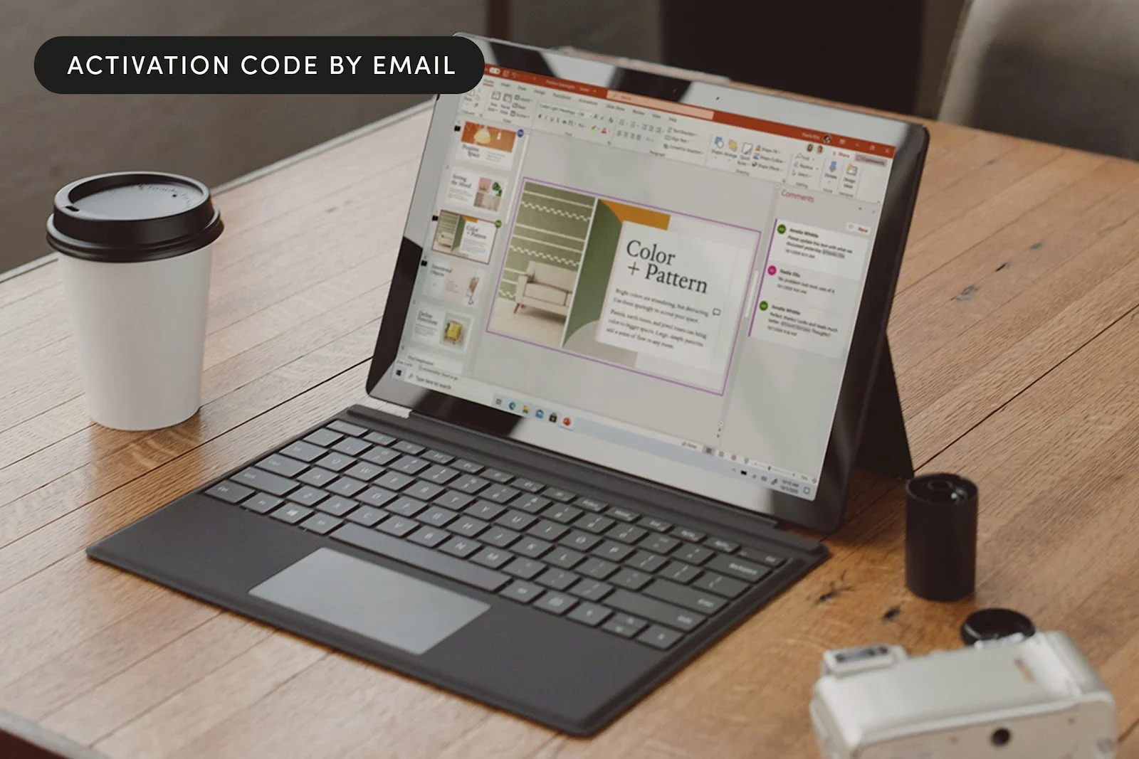 A laptop placed on top of a wooden table beside a cup of coffee.