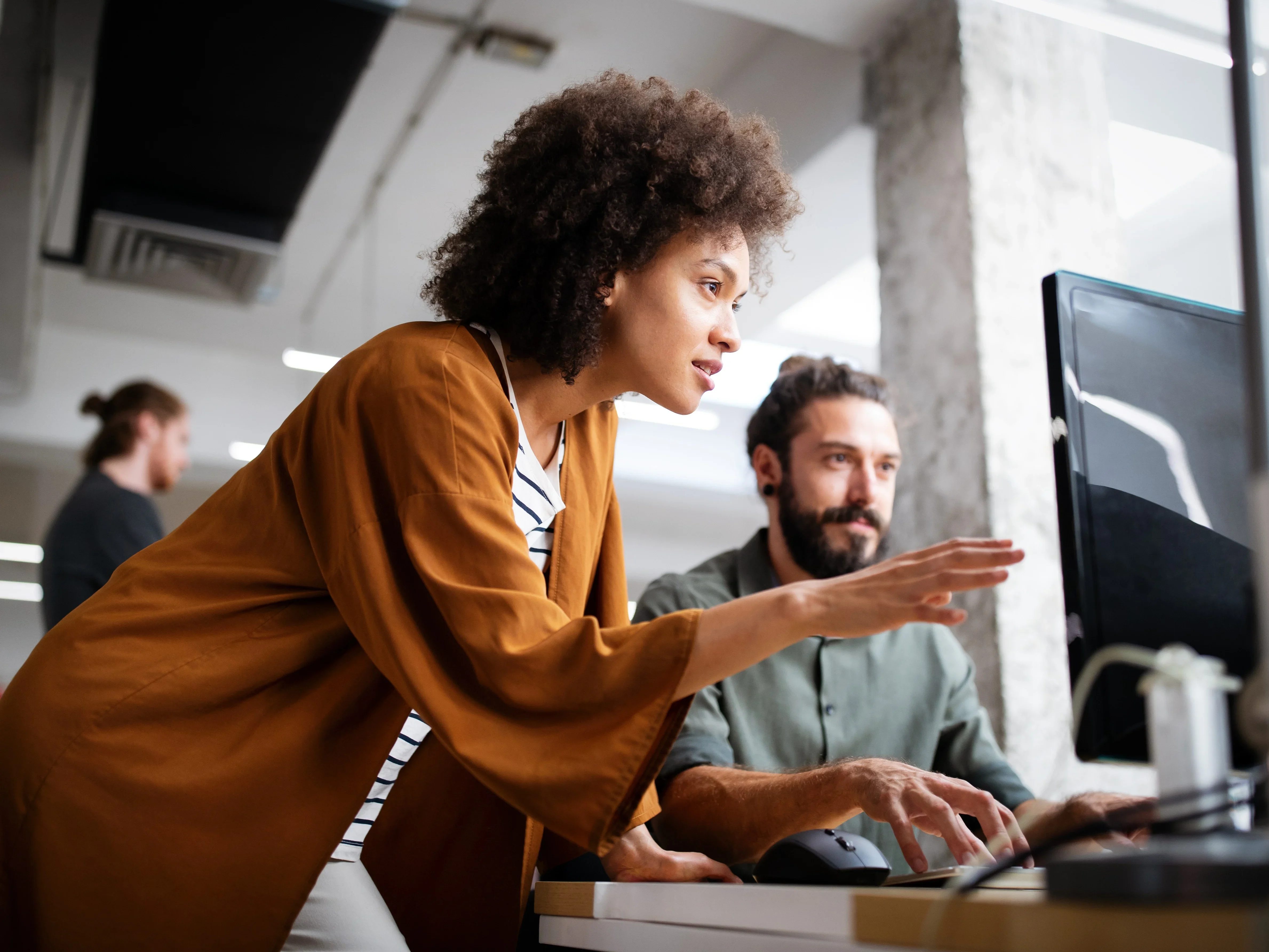 Team discussing and planning projects on a computer.