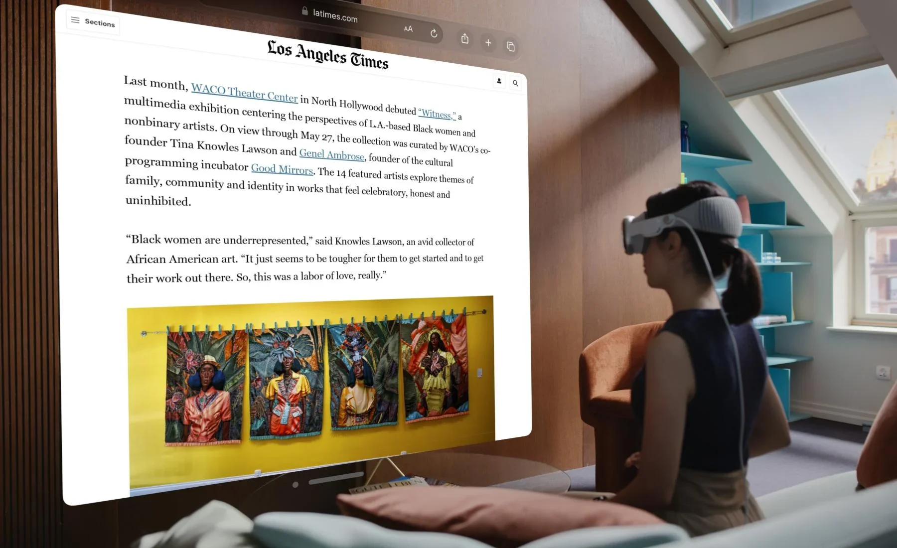 A person wearing a virtual reality headset facing away from the viewer and toward a screen rendering of the Los Angeles Times.