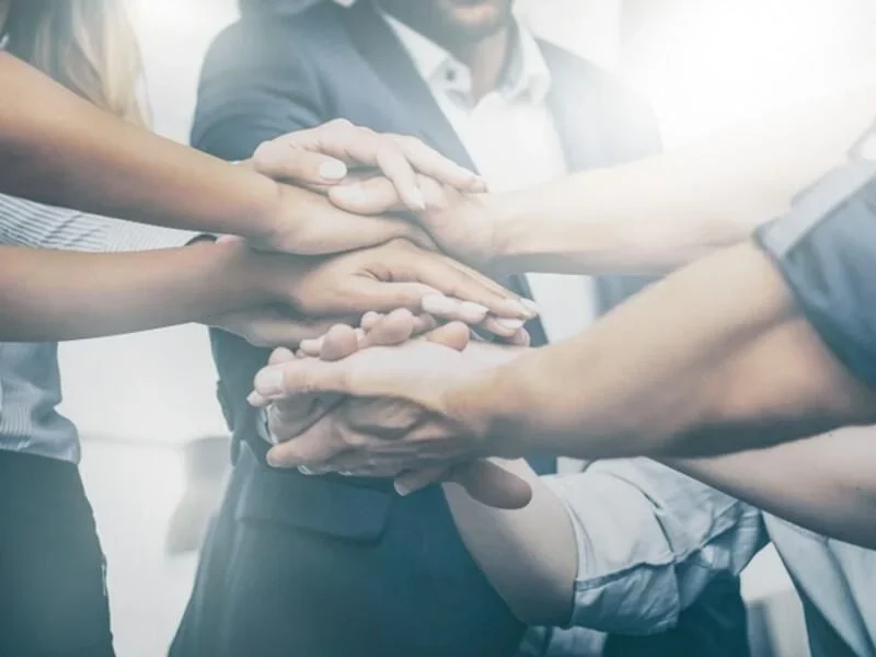 Diverse group of hands stacked up as a team